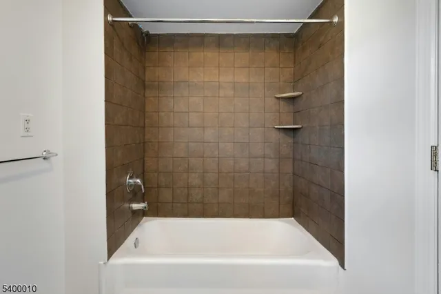 a bathroom with a shower and a bath tub