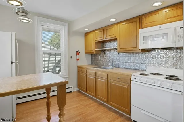 a kitchen with stainless steel appliances a stove sink and cabinets