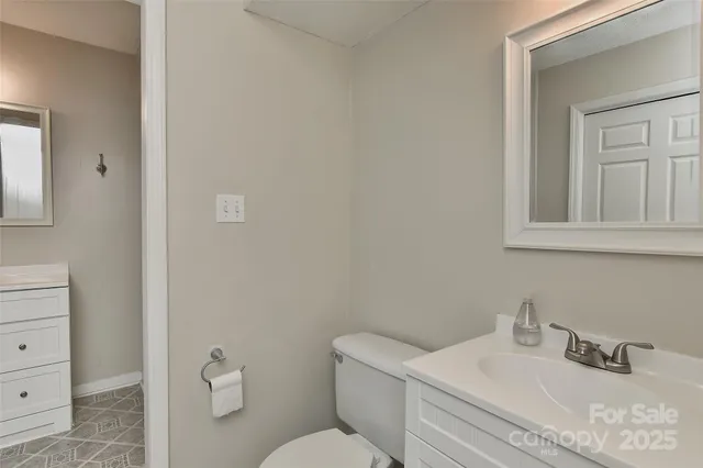 a bathroom with a sink toilet and mirror