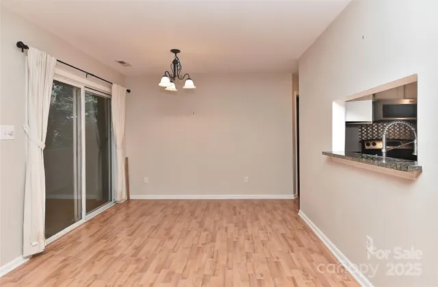 a view of a room with wooden floor