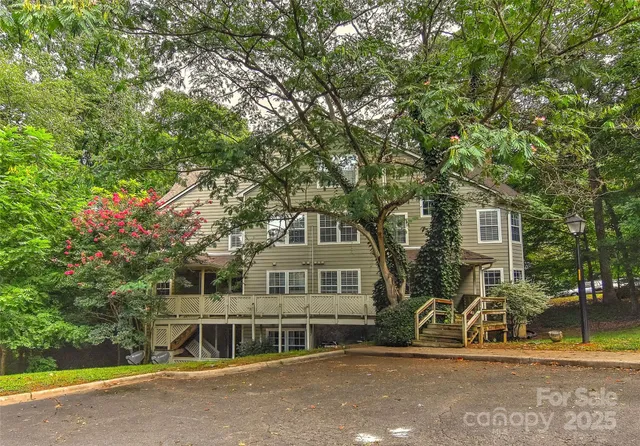 a view of a house with swimming pool and sitting area