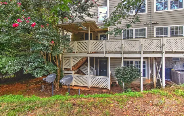 a front view of a house with a yard and bench