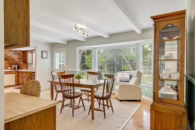 a dining room with furniture and wooden floor