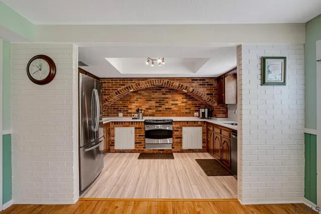 a kitchen with stainless steel appliances a stove and cabinets