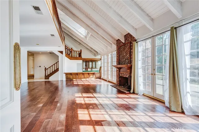 a kitchen with stainless steel appliances granite countertop a sink a stove and a refrigerator