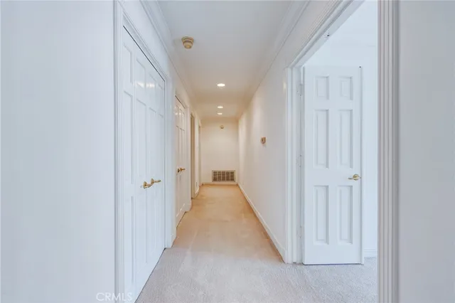 a view of staircase with lots of frames on wall and windows