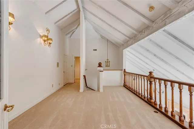 a view of a hallway with wooden floor and a cabinet