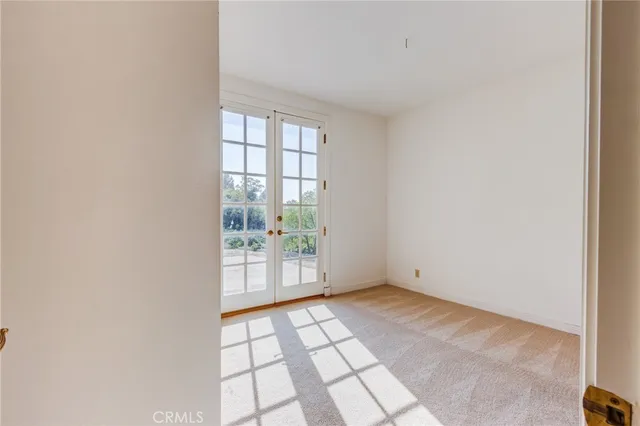 an aerial view of residential house with outdoor space and trees all around