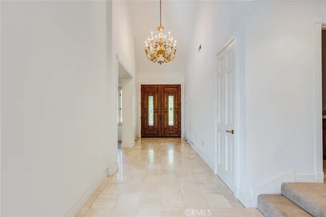 a bathroom with a chandelier fan and a window
