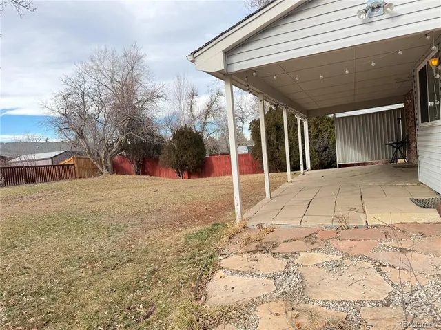 a view of large yard with a house and trees