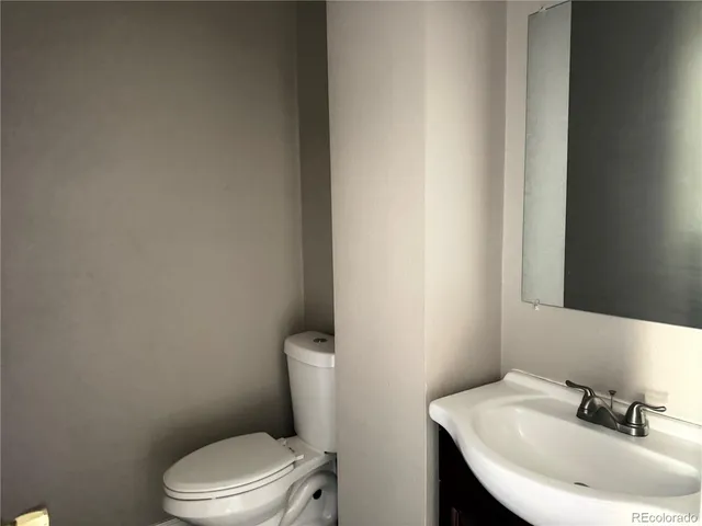 a white toilet sitting next to a bathroom sink