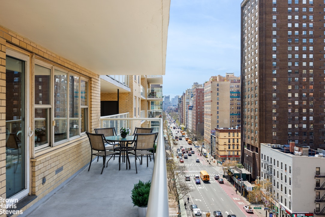 a city view with tall buildings and outdoor seating
