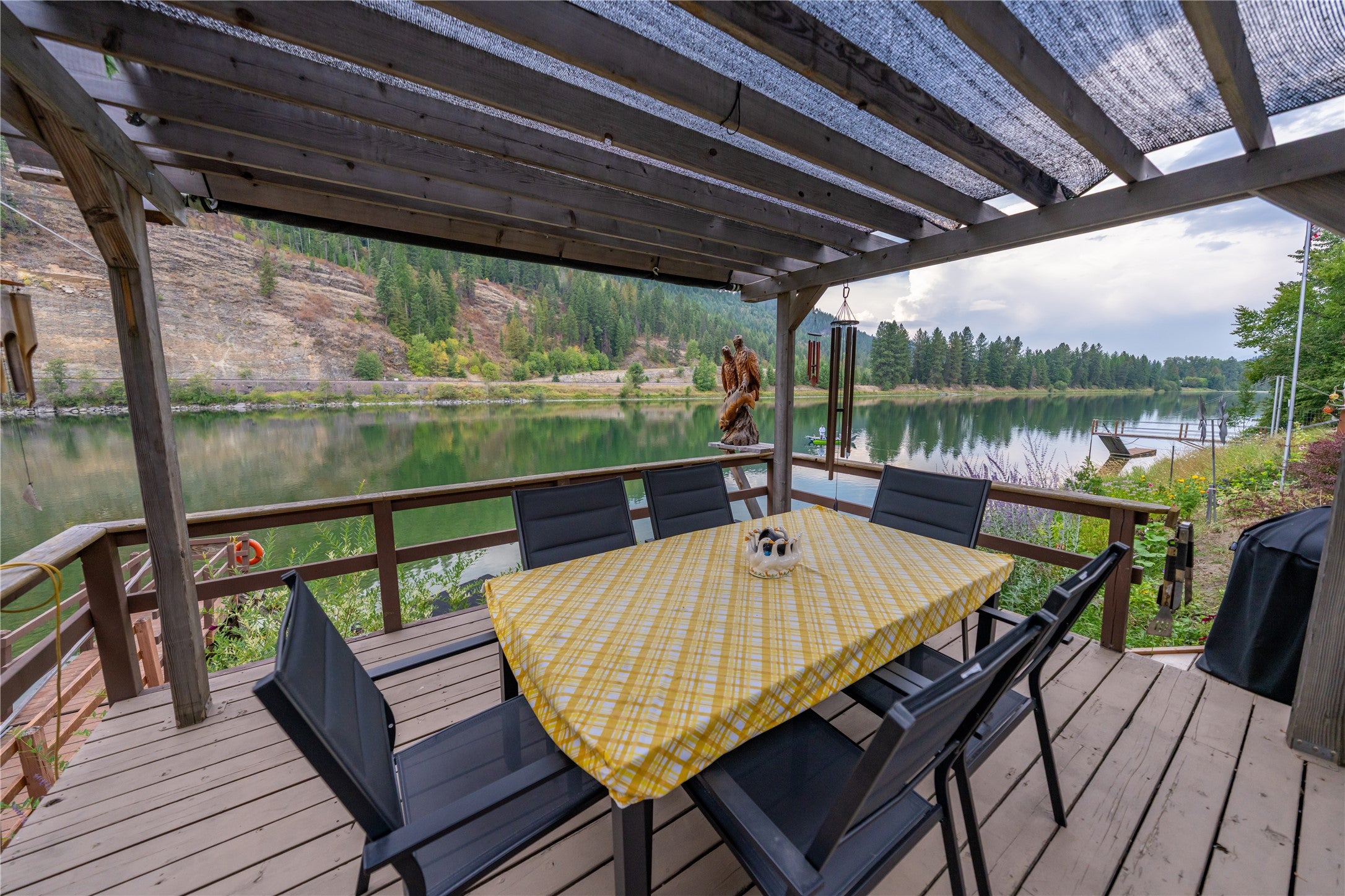 644 Waterfront Road Troy, MT 59935 - Photo 21 of 66 Wooden deck featuring a water view, outdoor dining space, and grilling area