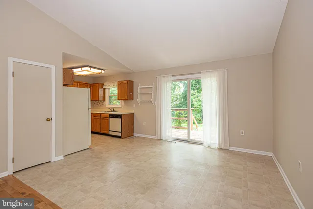 a view of a big room with windows and kitchen view