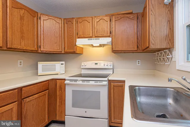 a kitchen with a stove and cabinets
