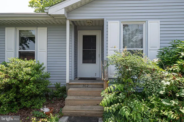 front view of a house with potted plants