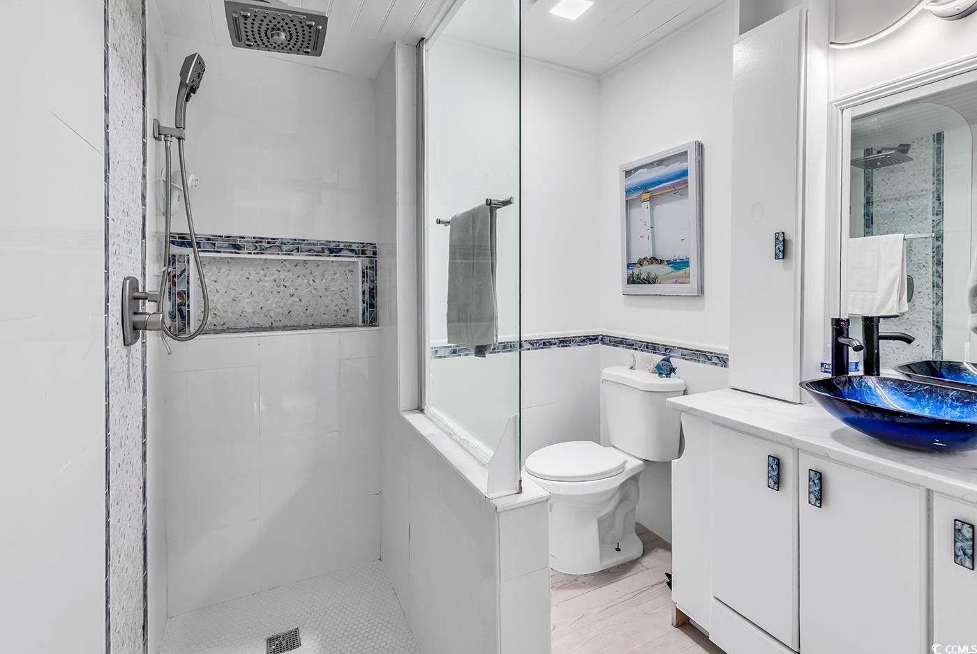 5114 Cowart Court Murrells Inlet, SC 29576 - Photo 15 of 38 Bathroom featuring toilet, tiled shower, vanity, w