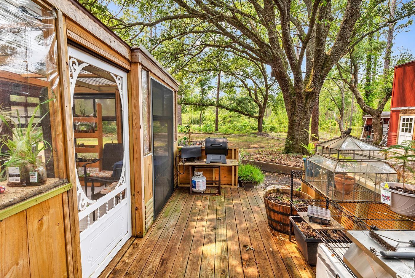 5114 Cowart Court Murrells Inlet, SC 29576 - Photo 24 of 38 Wooden terrace with a sunroom