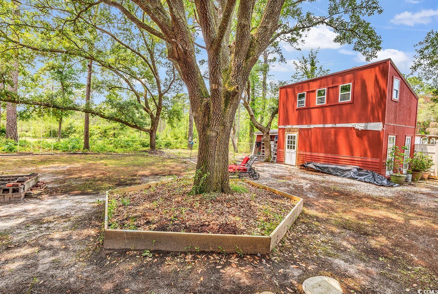 5114 Cowart Court Murrells Inlet, SC 29576 - Photo 25 of 38 View of yard with a garden