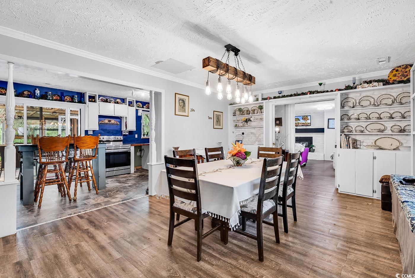Dining space featuring a textured ceiling, ornamen