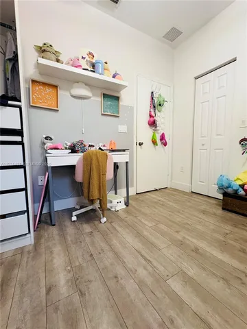 a bedroom with furniture and a gate