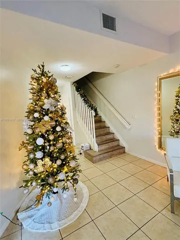a vase of flowers sitting on a floor