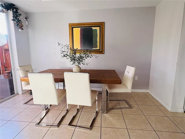 a living room with a table and a chair