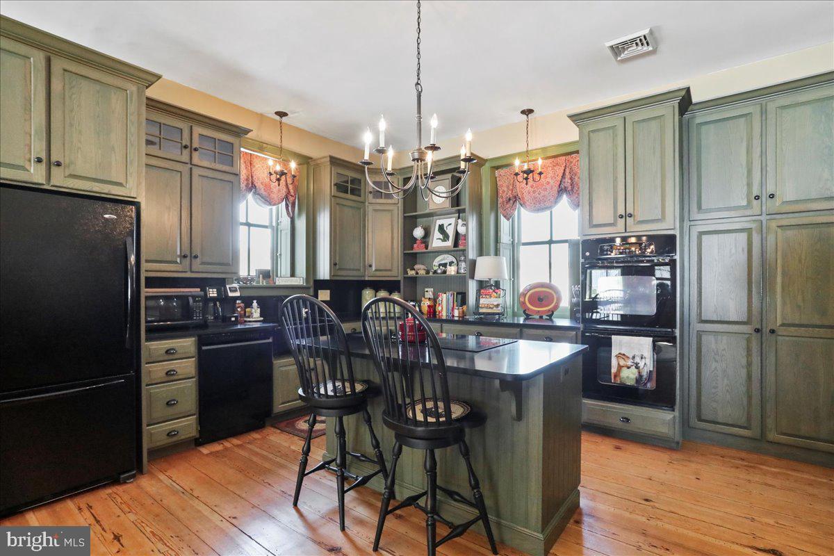 1-22020 Durberry Road Smithsburg, MD 21783 - Photo 61 of 138 a kitchen with stainless steel appliances granite countertop a refrigerator a stove top oven a sink dishwasher and wooden cabinets