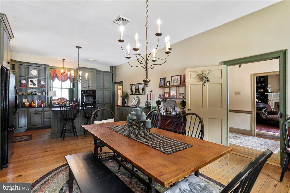 1-22020 Durberry Road Smithsburg, MD 21783 - Photo 65 of 138 a view of a dining room with furniture a chandelier and wooden floor