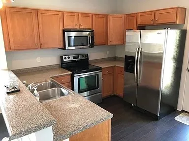 a kitchen with a refrigerator sink and microwave