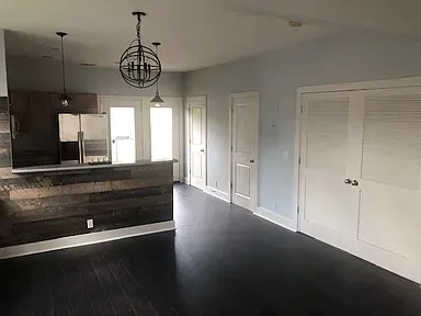 a view of room with window and wooden floor