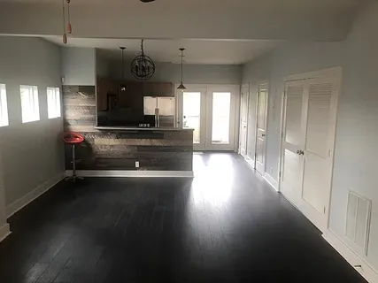 a view of a room with wooden floor