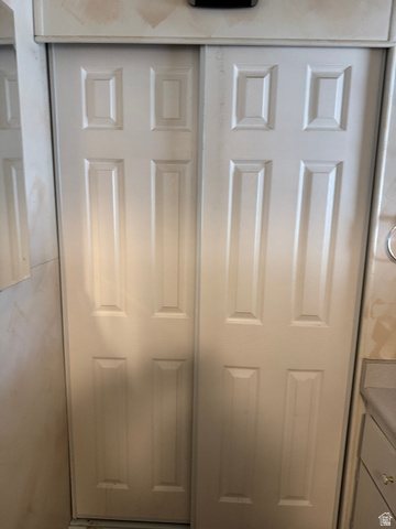210 South State Street Moroni, UT 84646 - Photo 13 of 23 White bi-fold doors with recessed paneling and a painted finish