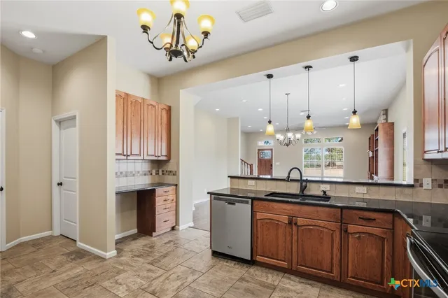 a kitchen with stainless steel appliances granite countertop a sink and cabinets