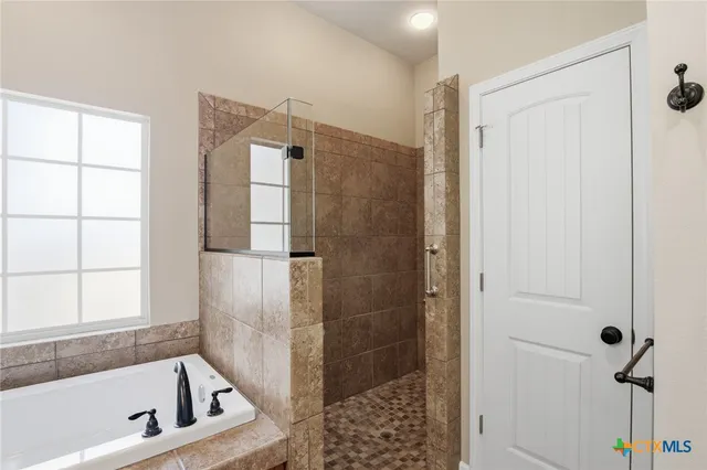 a bathroom with a bathtub and a shower