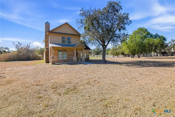 a front view of a house with a yard covered in snow