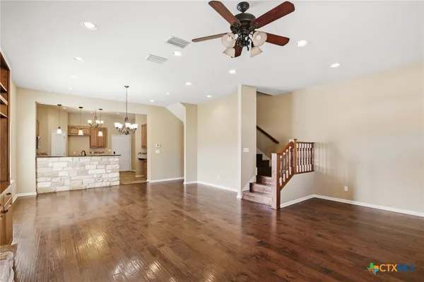 a view of an empty room and wooden floor