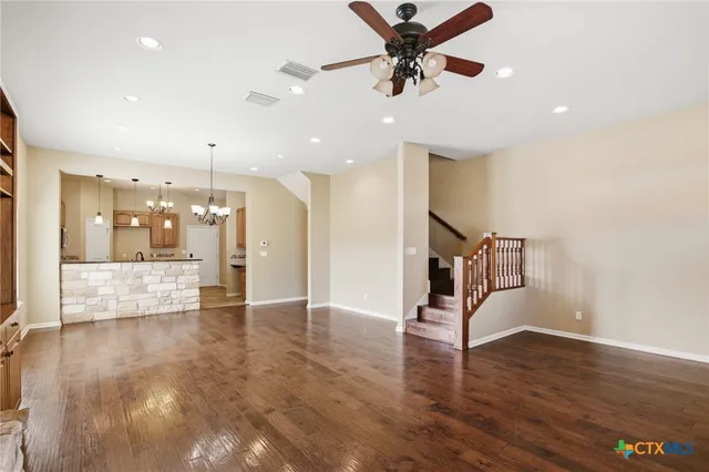a view of an empty room and wooden floor
