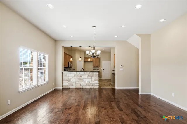 a view of a kitchen with wooden floor and window