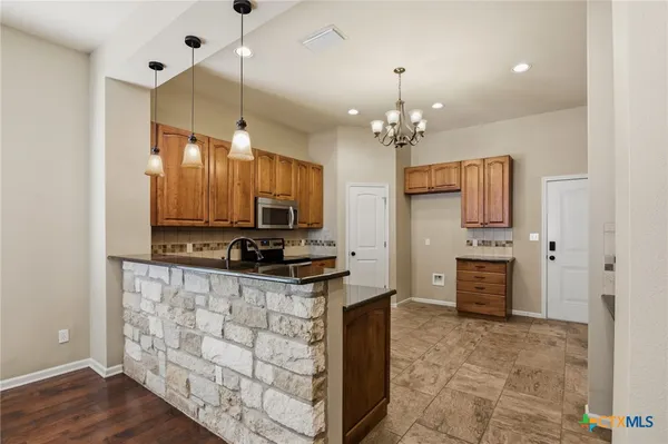 a kitchen with stainless steel appliances granite countertop a refrigerator oven a sink and dishwasher