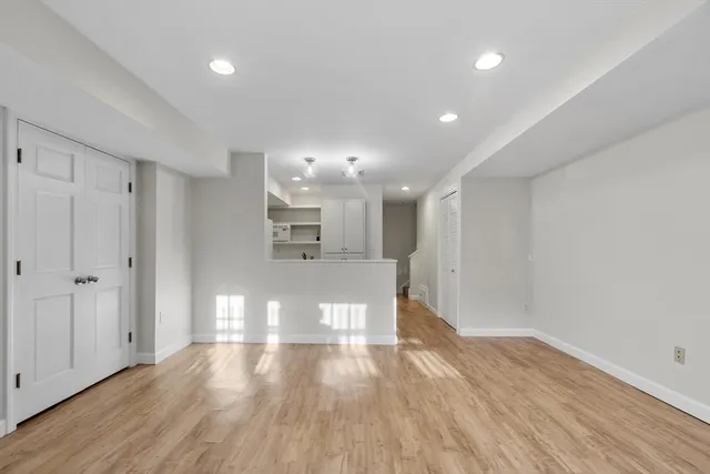 a view of empty room with wooden floor
