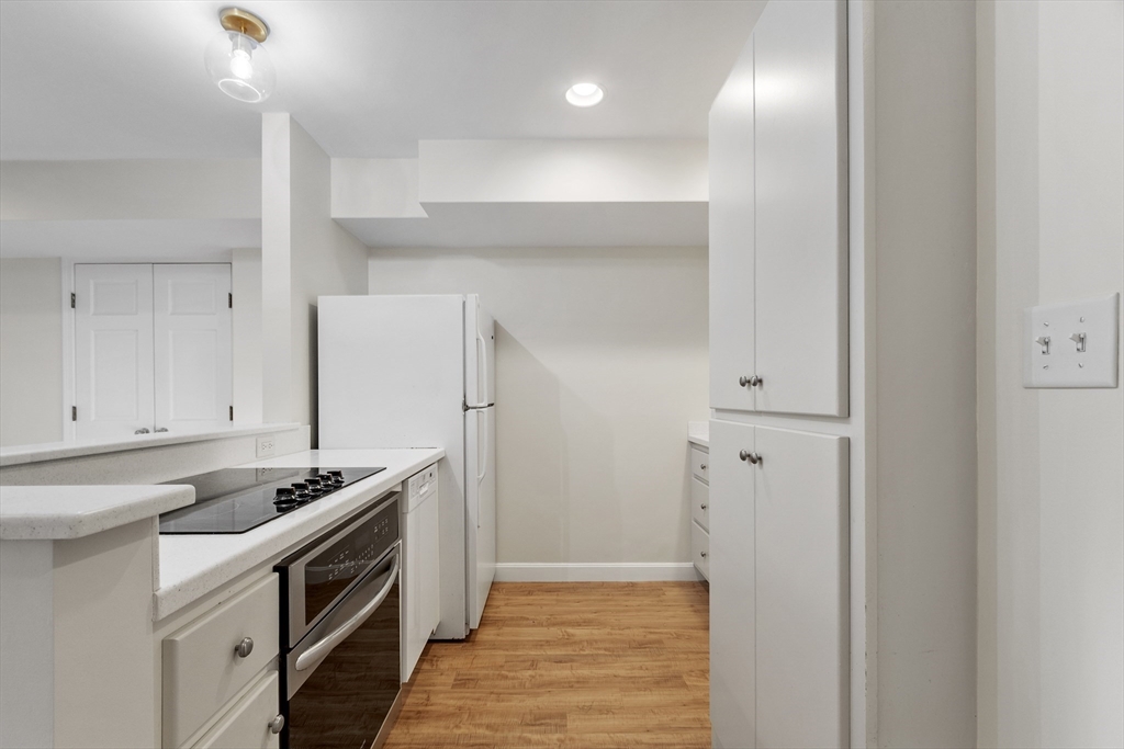 27 R West Street, Unit 8 Beverly, MA 01915 - Photo 5 of 21 a kitchen with stainless steel appliances granite countertop a refrigerator and a sink