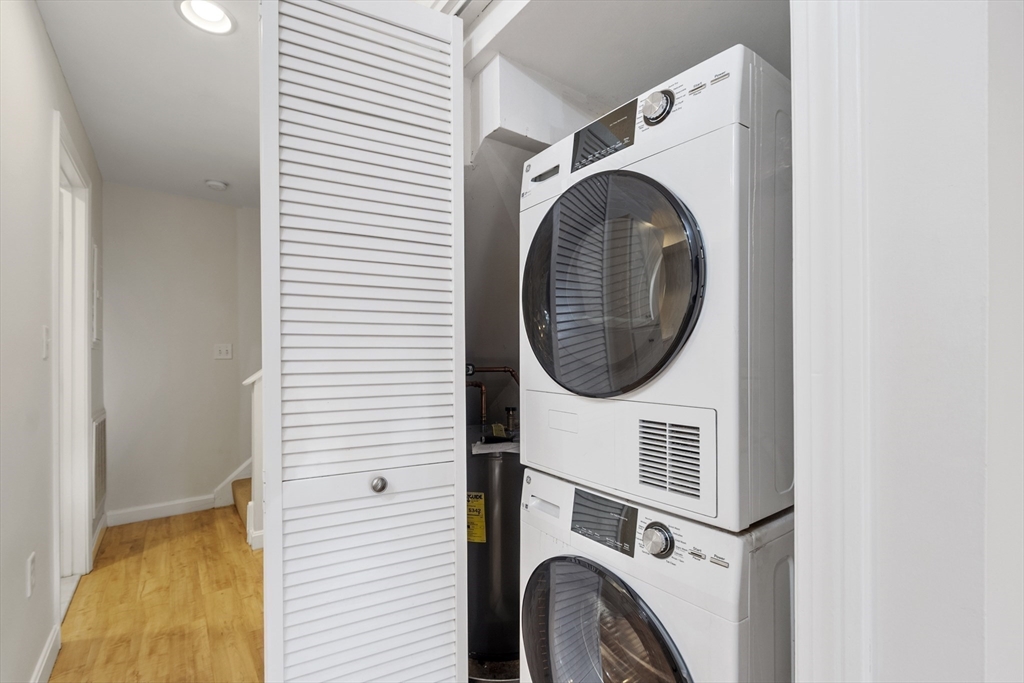 27 R West Street, Unit 8 Beverly, MA 01915 - Photo 7 of 21 a view of a hallway with washer and dryer