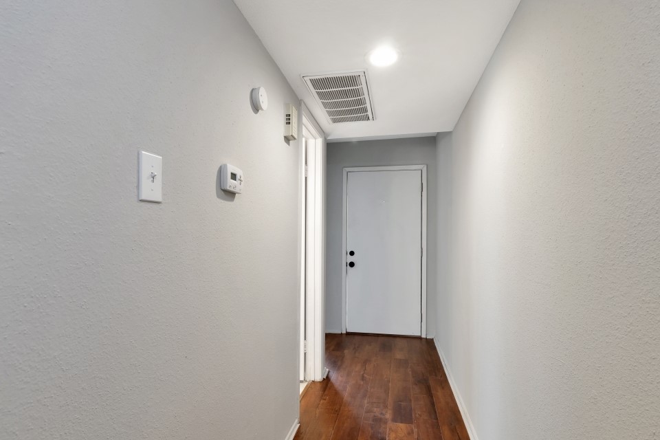 14777 Wunderlich Drive, Unit 1604 Houston, TX 77069 - Photo 3 of 19 a view of hallway with wooden floor