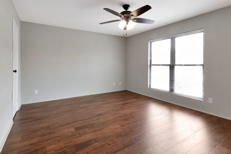 14777 Wunderlich Drive, Unit 1604 Houston, TX 77069 - Photo 4 of 19 an empty room with wooden floor and windows