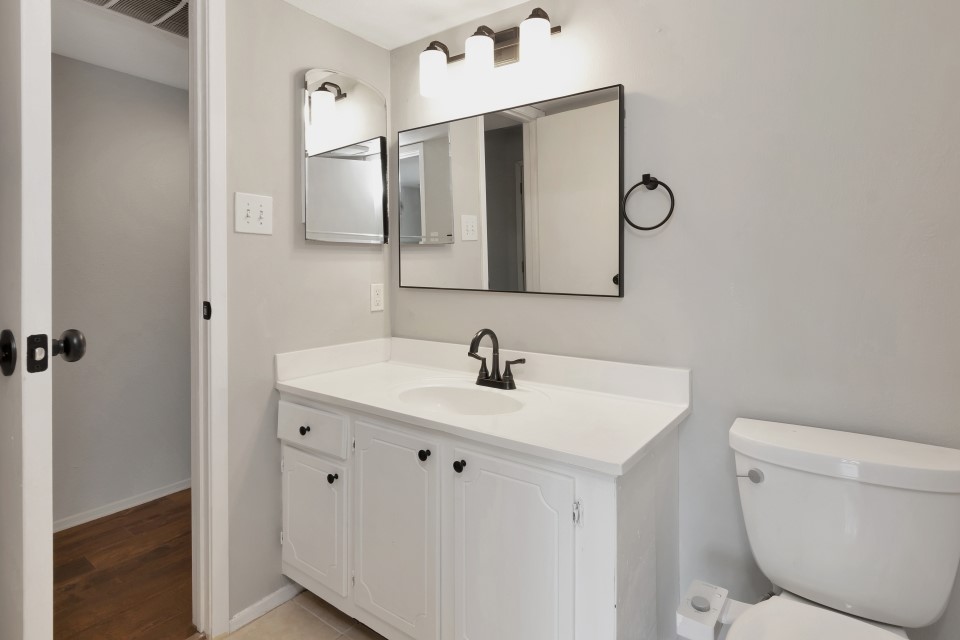 14777 Wunderlich Drive, Unit 1604 Houston, TX 77069 - Photo 7 of 19 a bathroom with a toilet sink and mirror