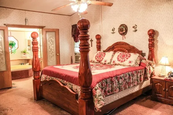 a bedroom with a bed and window