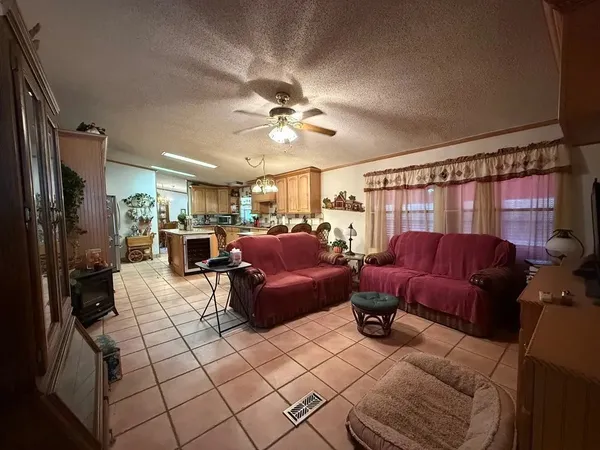 a living room with furniture ceiling fan and a rug