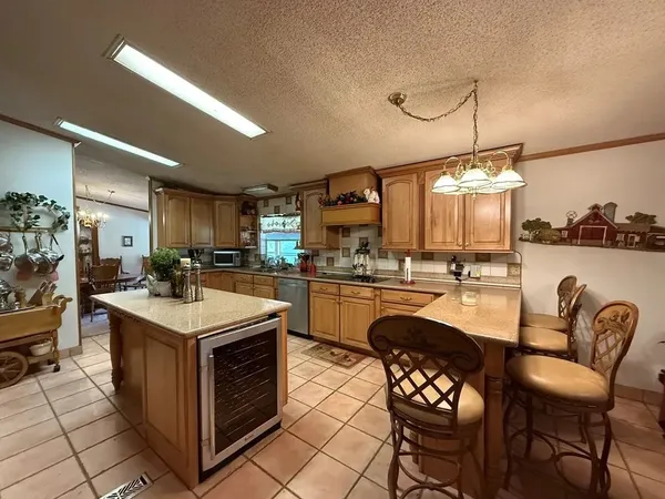 a kitchen with a stove a table and chairs