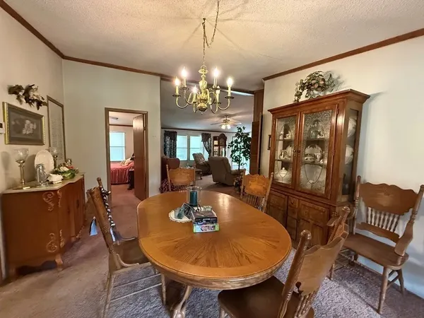 a view of a dining room with furniture and chandelier
